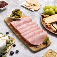 Assorted finger foods like ham, cheese, and fruit displayed on a table.