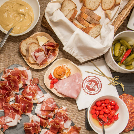 A beautifully arranged table filled with diverse foods, featuring an array of colors and textures that is good for sharing.