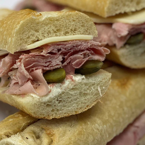 A Sandwich with Ham, Cheese and Olives.