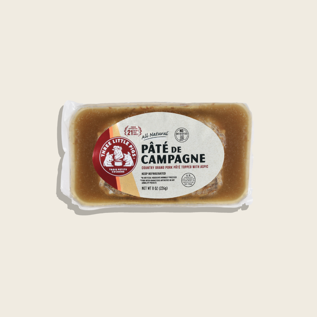 Packaged pété de campagne with a visible brand label on a beige background