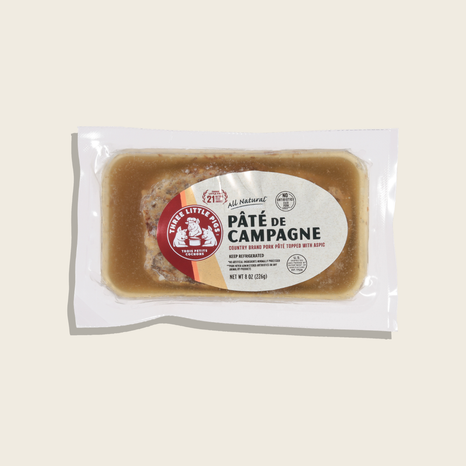 Packaged paté de campagne with a label on a beige background