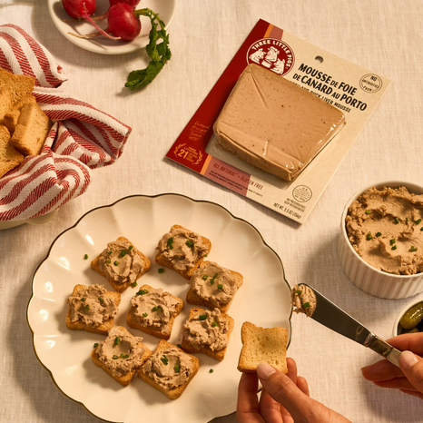 Mousse de Foie de Canard au Porto on toast with a package of Pate in the background.