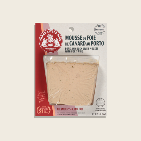 Packaged mousse de foie de canard au Porto with branding and product details on a white background