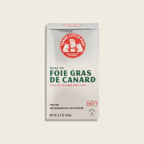 Packaging of 'Bloc de Foie Gras de Canard' with branding on a beige background