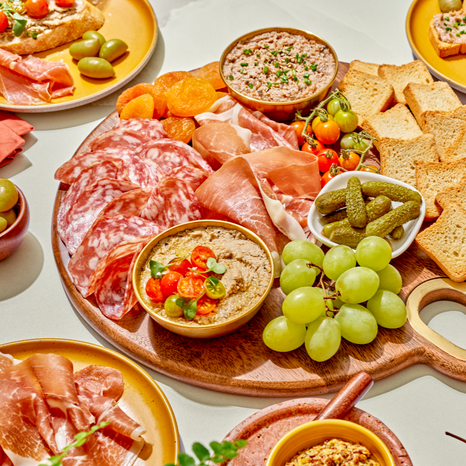 A gourmet selection in a wooden board features a variety of delicacies such as our Bloc de Foie Gras, Prosciutto, Green Lucques Olives, Petit Toast, & more. Perfect for celebrating every triumph, this charcuterie kit is certain to bring the rich flavors of France to your table this summer.