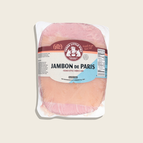 Packaged Jambon de Paris ham with a visible brand label on a beige background