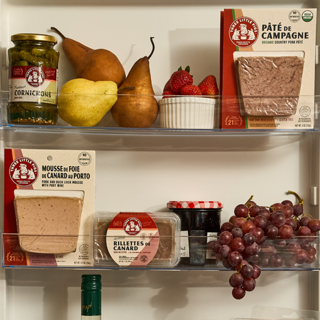 Shelf with various food items including pears, strawberries, and packaged foods.