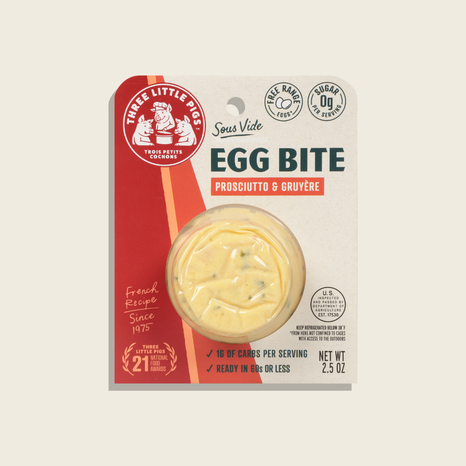 Package of Three Little Pigs Egg Bite with Prosciutto & Gruyère on a beige background