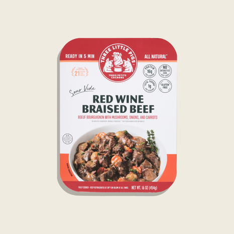 Package of 'Three Little Pigs' Red Wine Braised Beef on a beige background
