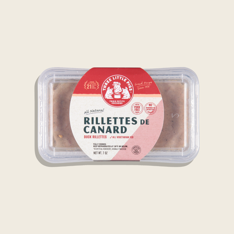Packaged duck rillettes with a red and white label on a beige background