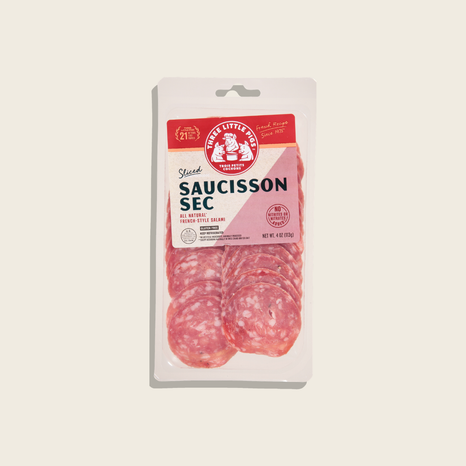 Packaged sliced saucisson sec on a beige background