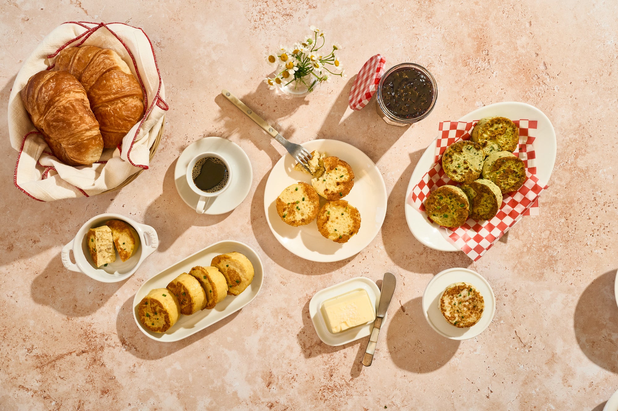 Breakfast spread with Egg Bites, coffee, and butter on a textured surface