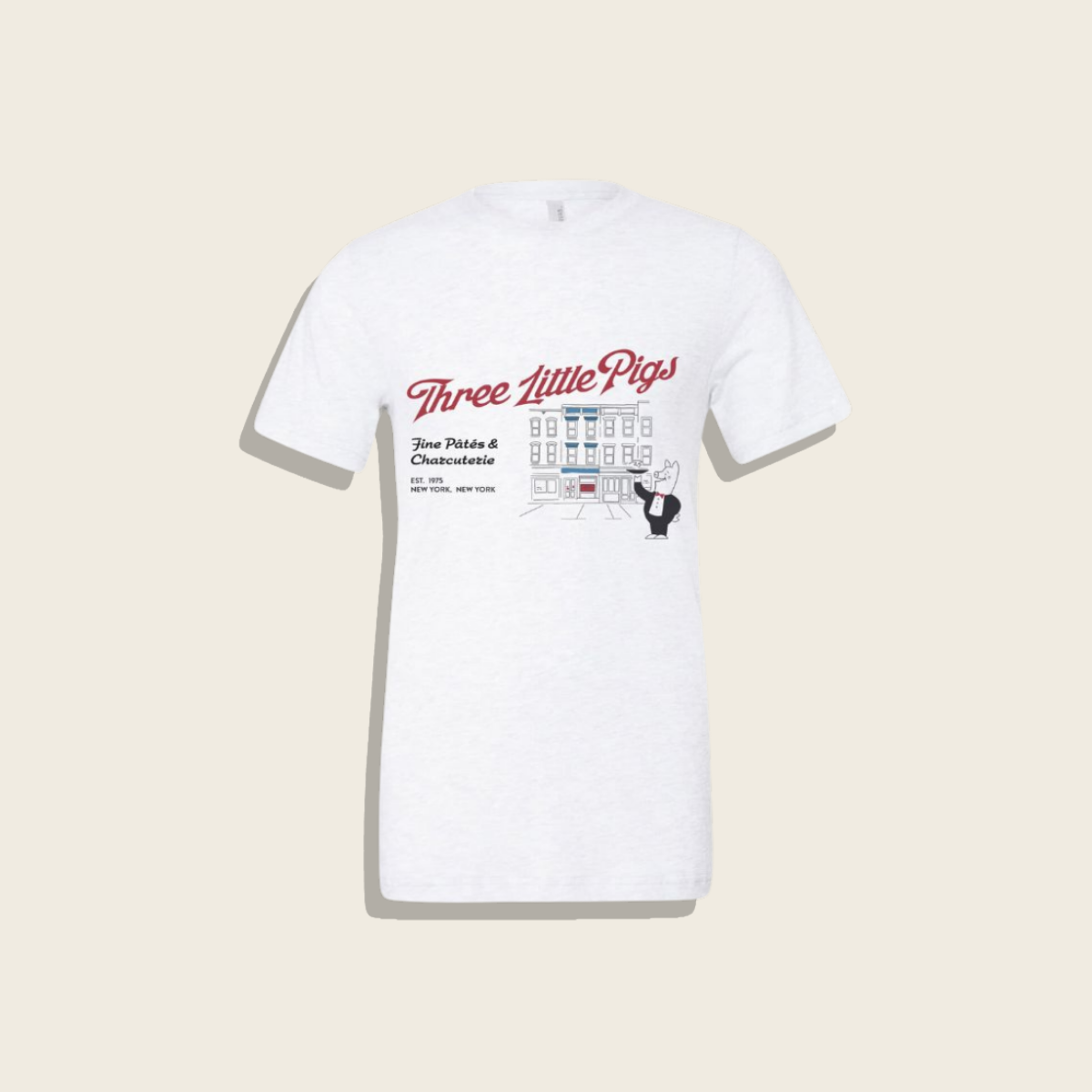 White t-shirt with 'Three Little Pigs' graphic design on a beige background